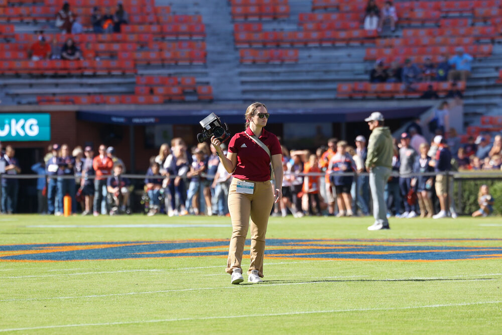 Savannah walking the field with her camera